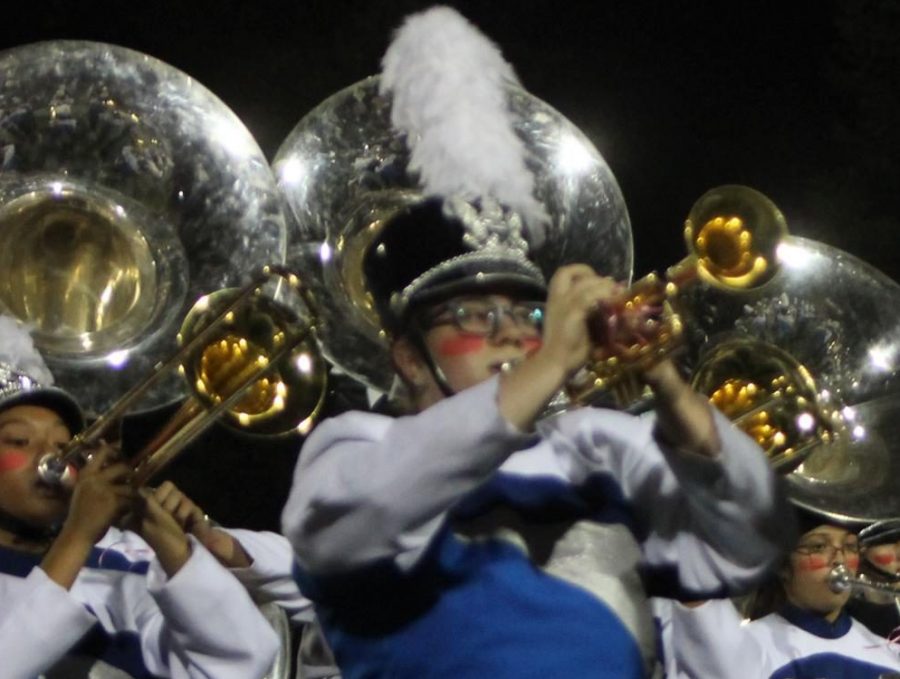 Junior Elyzabeth Marryman playing the trumpet as band performs at Oakmonts last football game of the 2018-19 school year.