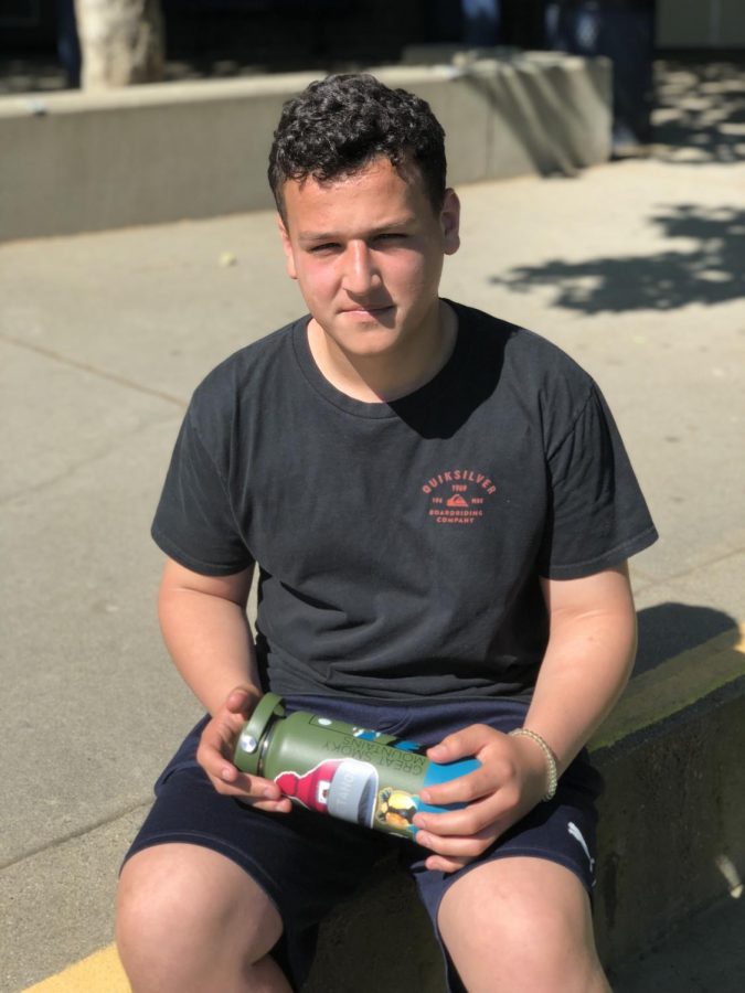 Tanner sits with his decorated Hydroflask, rather than a plastic bottle. 