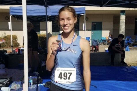 Sophomore Mia Hirsch celebrates with her medal finishing the FVL meet.