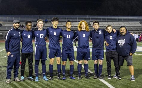 Senior boys soccer players line up for one last picture with their coaches (from left to right): coach Tom Sinner, Njabulo Mkhize. Jake Neiman, Ben Gonzalez, Christian Barajas, Noah Collins, Javi Gonzalez, Pete Gonzalez, and coach Pete Gonzalez.