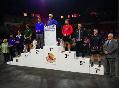 Junior Sean Myles (far right) on the winner's podium after taking seventh place at the CIF State Wrestling Championship.