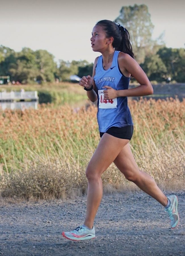 Junior XC athlete Lois Sison racing in a meet before the pandemic started.