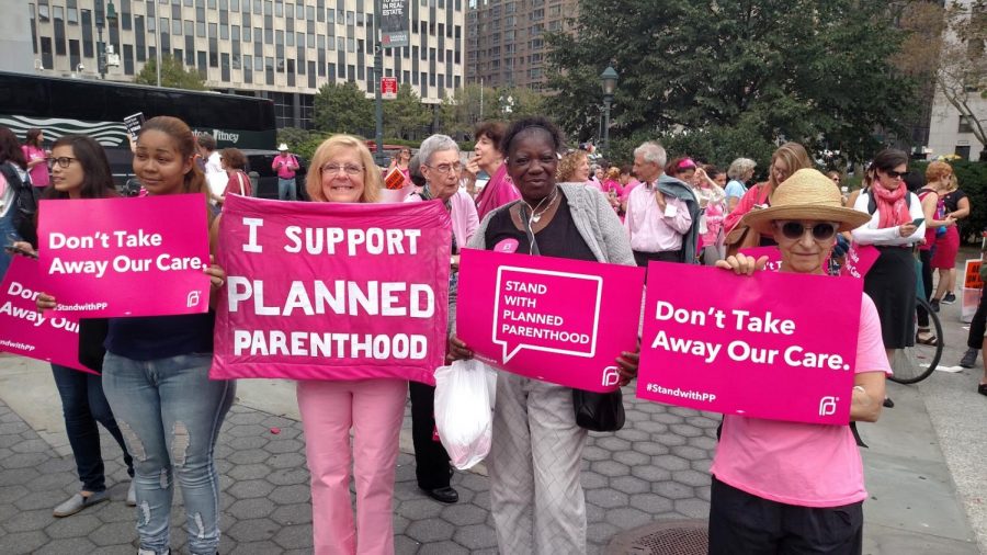Women pose at the Planned Parenthood Pink Out in 2015 in New York, New York.
