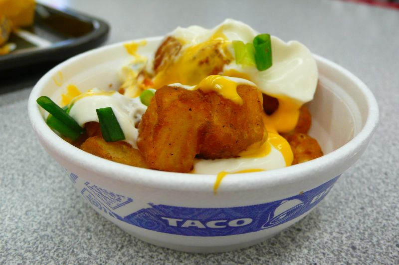 Taco Bells fiesta potatoes are golden brown potatoes, topped with sour cream, and cheese.