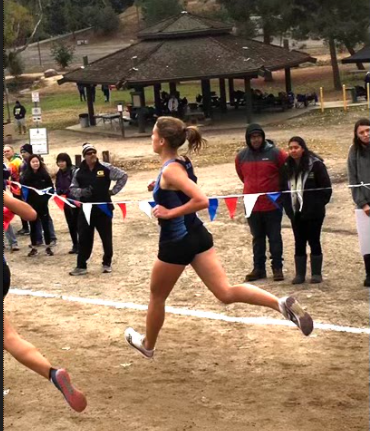 Junior Mia Hirsch running in a cross-country meet last season