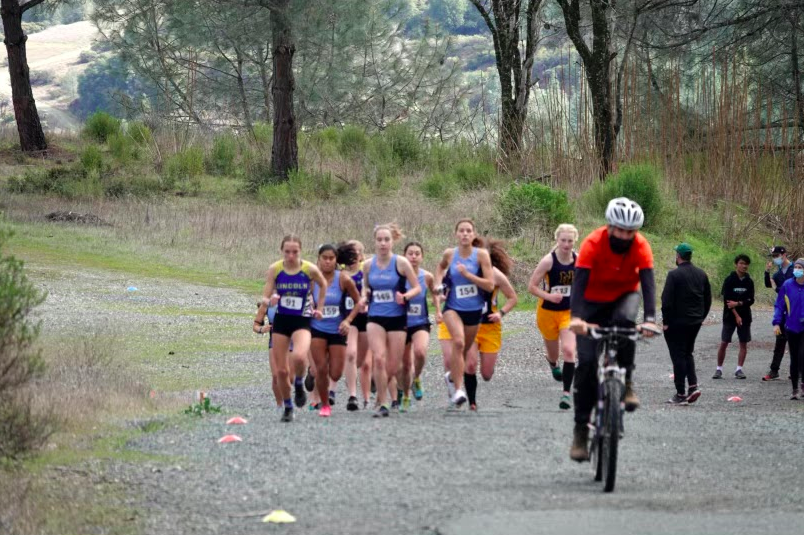 Varsity+Girls+running+in+their+first+meet+since+last+season.