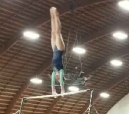 Lutrel performing on bars, her favorite area in the gym.