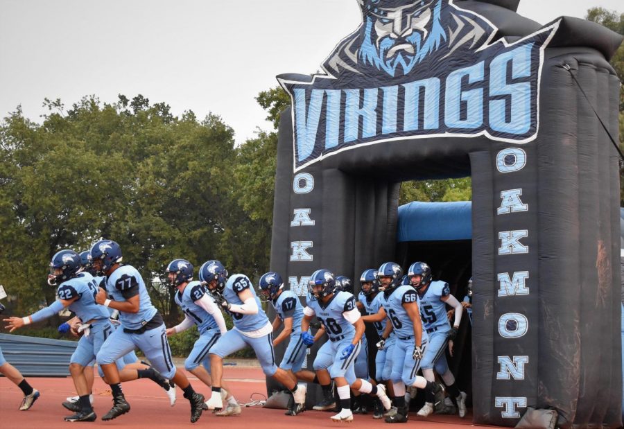 The Oakmont varsity football team make their entrance into the first game of the year.