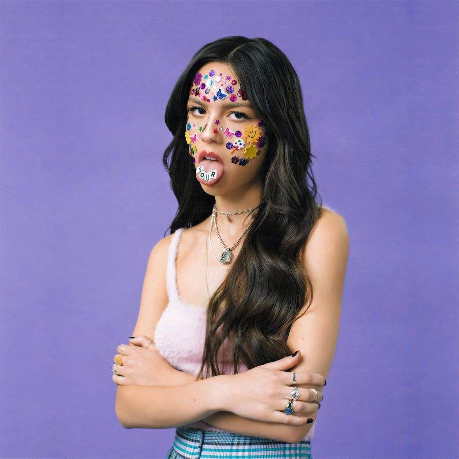 Rodrigo’s album cover picturing her with “SOUR” spelt out on her tongue and stickers covering her face.
