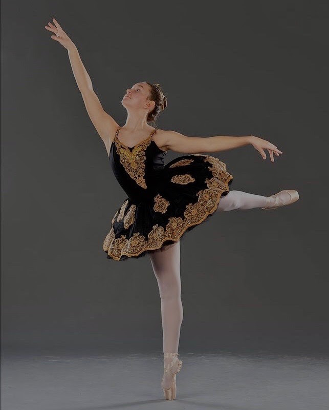 Schwartz in her full costume, and in a second arabesque