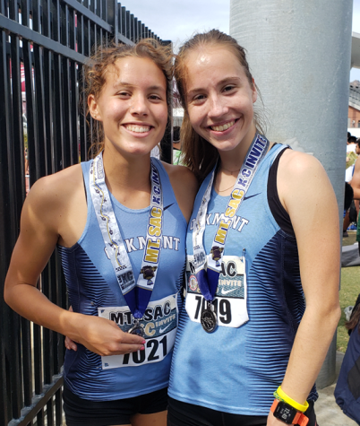 Seniors Mia Hirsch and Peyton Fisher
stand proudly with their medals.