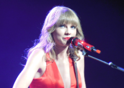 Swift beams as she performs on her “Red” Tour in 2013.
