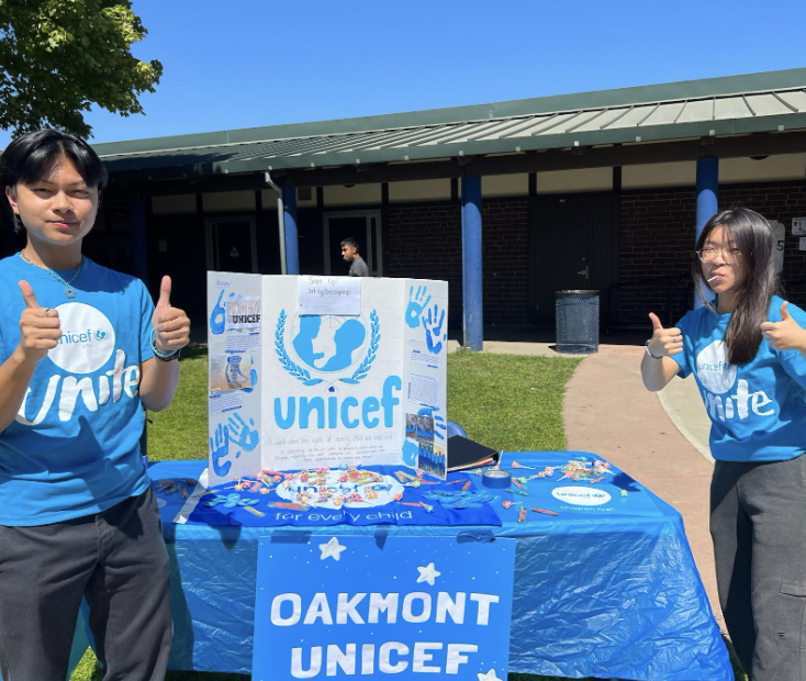 Members Matthew Boquiren and Victoria Liu at their decorated UNICEF stand. 