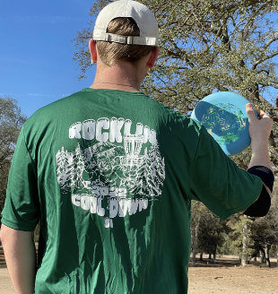 Player wearing 2022 Rocklin Cool Down shirt and holding disc.
