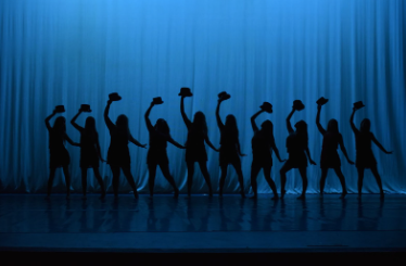 Silhouettes of the dancers performing a dance choreographed by Mrs. Huber and senior Alyssa Ivey. 
