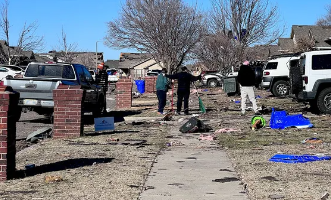 People in Norman, Oklahoma cleaning up their neighborhood after the storm.
