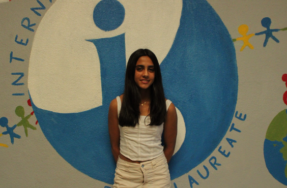 14-year-old student Abriena Bains standing in front of the International Baccalaureate mural at Oakmont High School. PC: Peyton Anderson