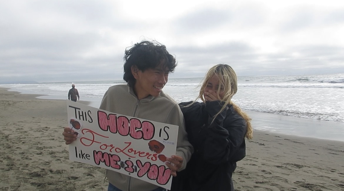 Micheal Sevilla and Scarlett Martin pose with their homecoming ask poster. PC: Scarlett Martin
