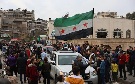 Syrians wave the Syrian opposition flag after rebels take Hama. PC: EPA pics
