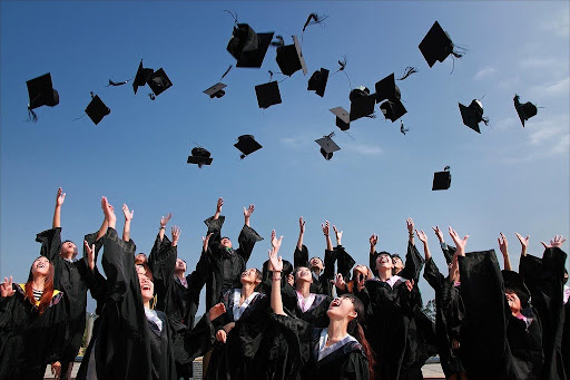 An image including graduates throwing their caps. PC: Pixabay
