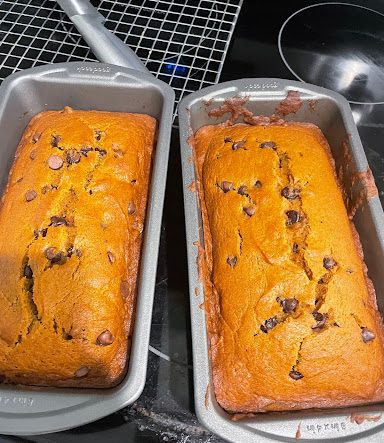 Two loaves of pumpkin chocolate bread fresh out of the oven.