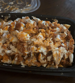 Photo of a chicken and fries plate served at Kiki's Chicken, showcasing the crispy chicken, fries and sauce.