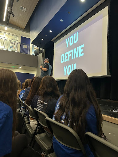 Speaker Carlos Ojeda Jr. on stage in front of Oakmont and inter-/intra-district students