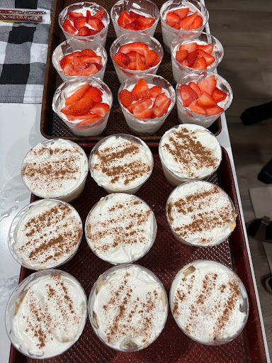 Mini homemade pumpkin and strawberry cheesecakes in cups.
