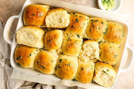 Freshly baked mashed potato rolls with the garlic butter topping added. PC: The Endless Meal

