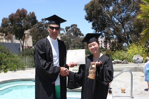 A student receives her Underwater Basket Weaving certificate next to the UCSD pool. PC: UWBW
